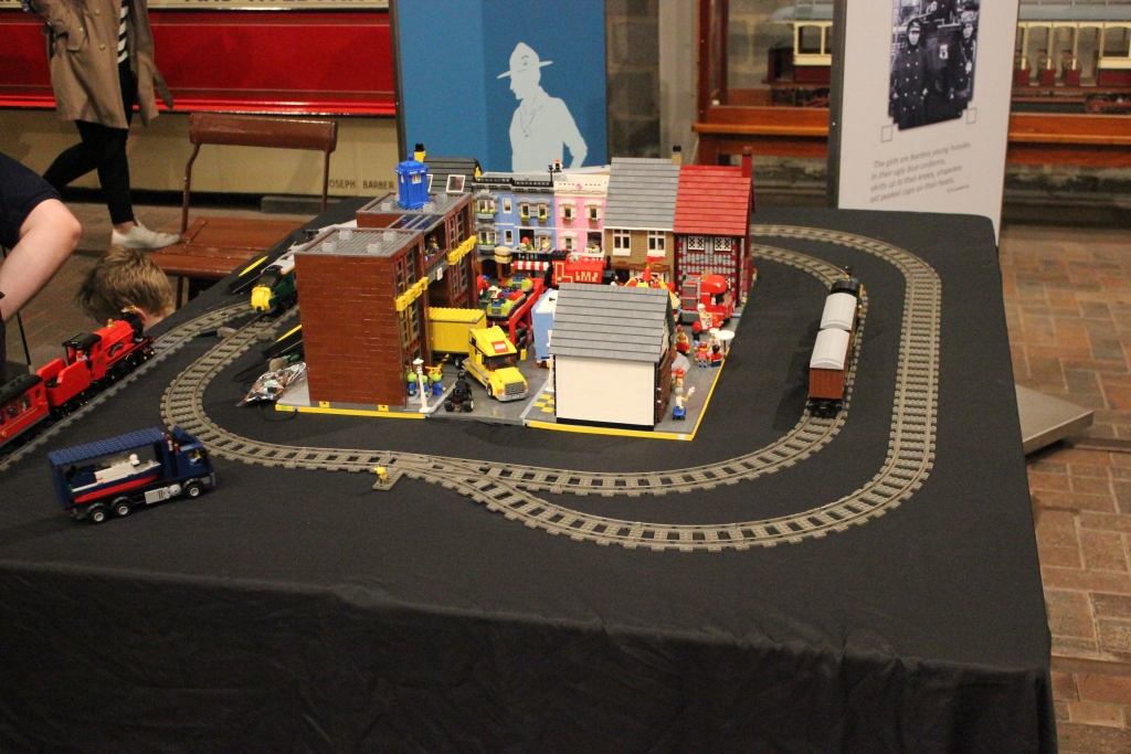 A display of LEGO trains and part of a LEGO city