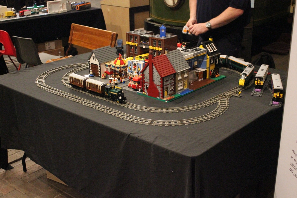 A display of LEGO trains and part of a LEGO city