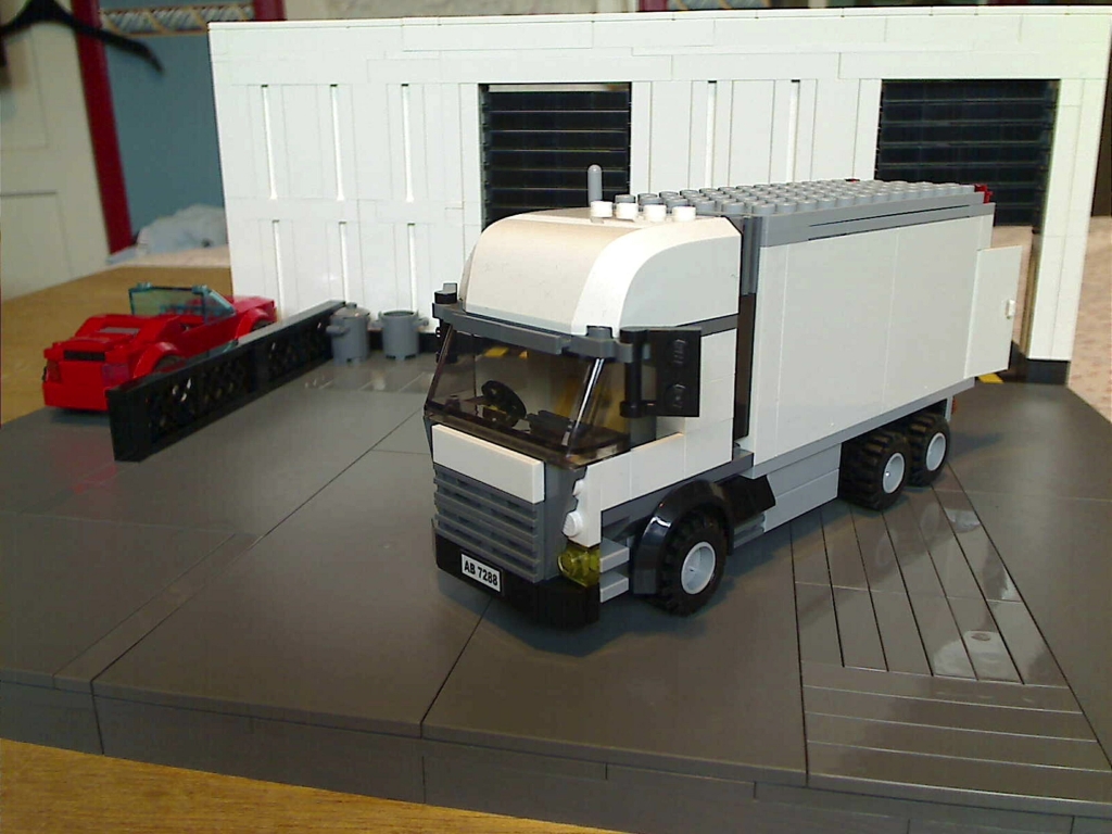 A view of the small lorry outside my warehouse built from LEGO bricks.