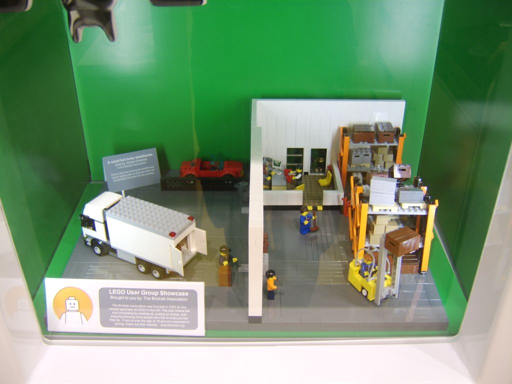A small scene in a warehouse built from LEGO bricks installed in the Cardiff Lego Store LUG Showcase.